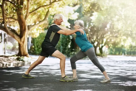 Supporting each other through their path down fitness. a senior couple warming up before a run outside. Az életmódváltás jótékony hatása a mindennapjainkra